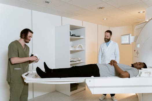 Doctors and patient during MRI scan in medical facility.