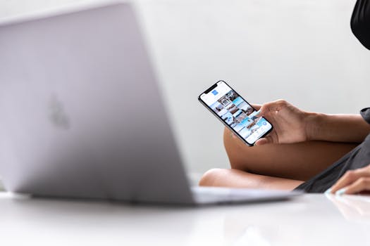 A woman multitasks using a smartphone and laptop, symbolizing modern digital nomad lifestyle in Bali.