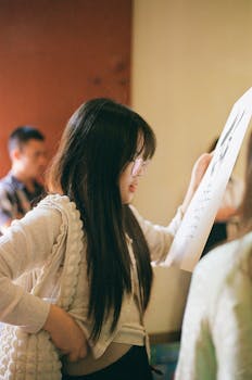 A young woman reads an art piece in a gallery in Hanoi, Vietnam.