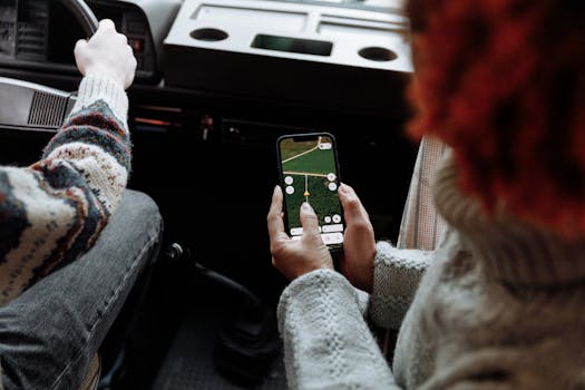 Two people using a navigation app on a smartphone during a road trip